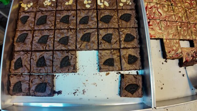 Chocolate Brownie Squares with Oreo and Nuts Displayed in Tray, Street Food Dessert, 4K