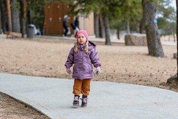 Fototapeta premium Cute little child girl outdoor in spring cloudy