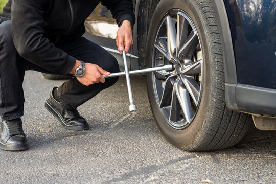 Changing a car tire, safely replacing a flat or worn tire with a new one, ensuring vehicle mobility, safety, and proper road performance.
