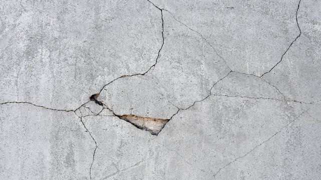 old plaster on the wall, cement, adhesive for screed. the old clay wall is crumbling. surface wall for vintage background. Wall texture, cracked plaster, grey cement floor, needs repair, restoration