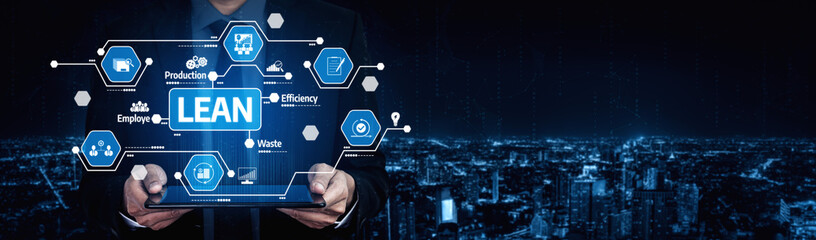 A businessman presents a tablet displaying lean management concepts against a nighttime city...