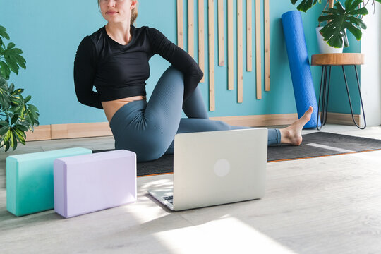 Young attractive woman practicing yoga sitting in Ardha Matsyendrasana