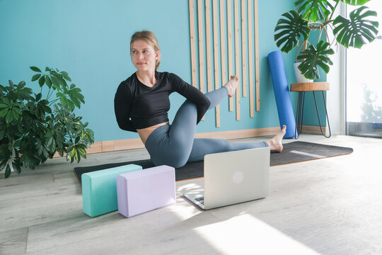 Young attractive woman practicing yoga sitting in Ardha Matsyendrasana