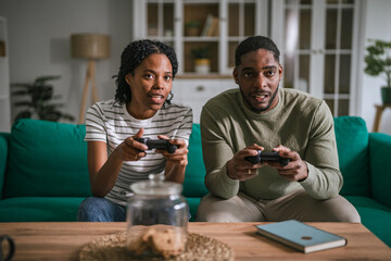 Young couple playing video games together at home © Miljan Živković