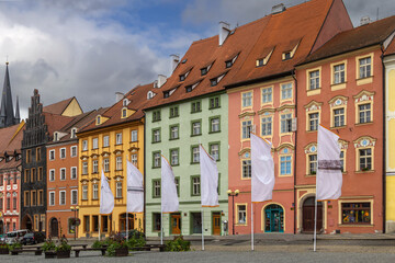 Fototapeta premium Historical houses in main market square of Cheb, Czech Republic. Old town architecture with colorful facades under cloudy sky
