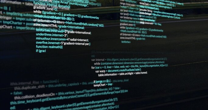 Showing syntax-highlighted code columns scrolling on widescreen monitor at desk, with reflections