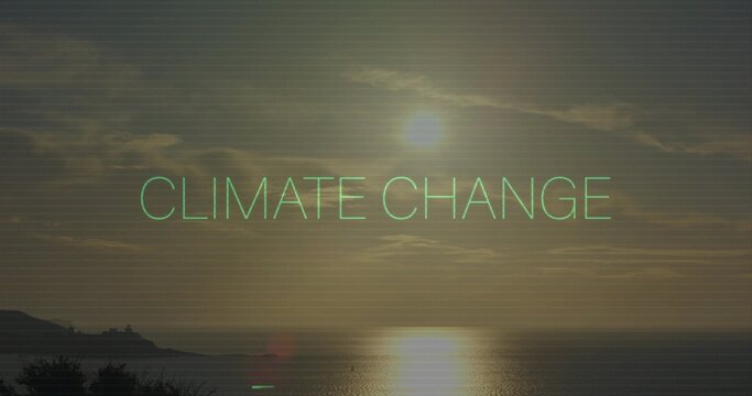 Glowing neon-green text CLIMATE CHANGE spanning coastal sea at sunset, showing sun reflection