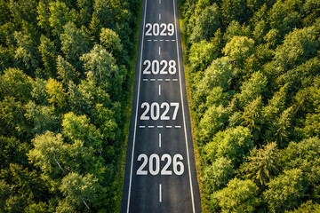 Fototapeta premium Aerial forest road view with years 2026 2027 2028 2029 for upcoming business strategy timeline annual growth planning and future development goals on asphalt way track