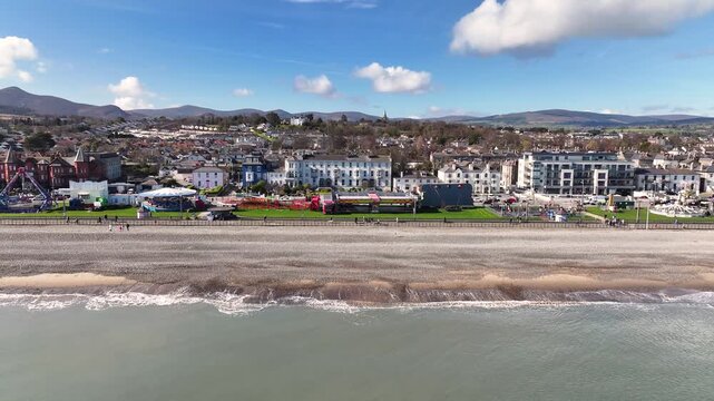 Beautiful aerial of Bray town, promenade with amusement park and beachfront buildings. Ireland