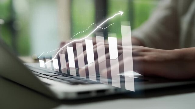 Close-up view of hands typing on a laptop, with an overlay of a graph depicting growth, symbolizing success and digital analysis in a modern workspace. Copula