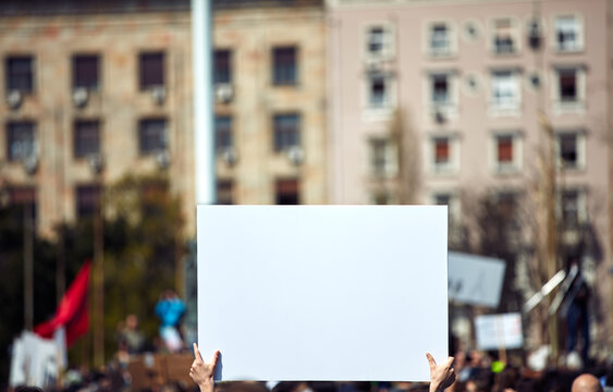Protesters holding placards and signs on the streets.