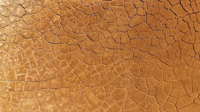 Aerial view of cracked red earth and dry mud patterns in the mining landscape of Minas de Riotinto, Andalusia, Spain.