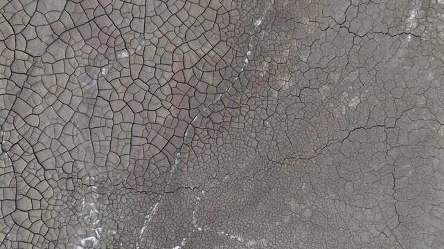 Aerial view of the intricate patterns of cracked dry earth and mineral deposits in the mining landscape of Minas de Riotinto, Andalusia, Spain.