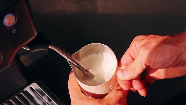 Top Down Close Up Of Hands Frothing Milk In Pitcher With Steam Wand Creating Microfoam In Slow Motion, Barista Coffee Routine