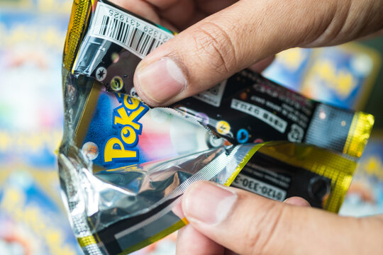 Bangkok, Thailand - April 2, 2026 : Selective focus A Pok&eacute;mon trading card booster packs is opening.