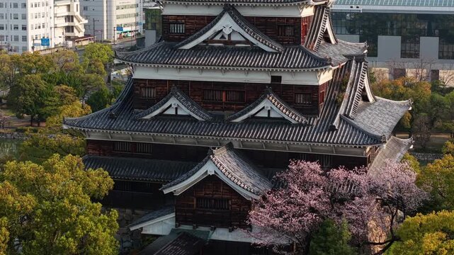 Close aerial view of Hiroshima Castle with cherry blossoms