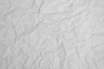 Naklejka premium crumpled sheet of white paper, abstract background, texture