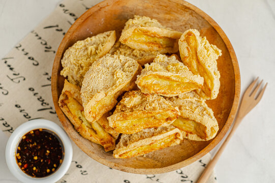 Tahu Walik, Inside Out Crispy Tofu Stuffed is a processed tofu snack fried in starch and other ingredients with Meatball Tahu Walik also known as Tahu Bakso, served on the table on a plate