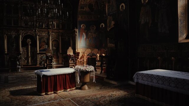 Soft natural light highlights the decorated baptismal font adorned with delicate flowers, placed at the center of an Orthodox church