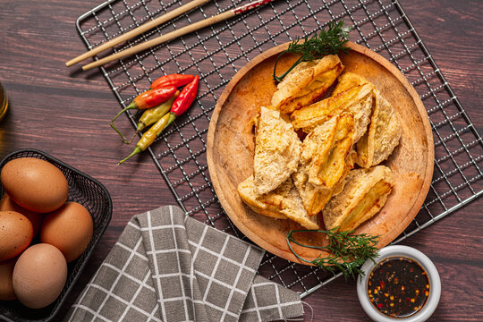 Tahu Walik, Inside Out Crispy Tofu Stuffed is a processed tofu snack fried in starch and other ingredients with Meatball Tahu Walik also known as Tahu Bakso, served on the table on a plate