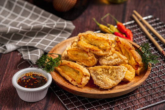 Tahu Walik, Inside Out Crispy Tofu Stuffed is a processed tofu snack fried in starch and other ingredients with Meatball Tahu Walik also known as Tahu Bakso, served on the table on a plate