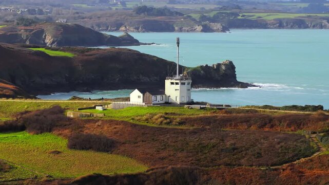 Aerial view of Pointe du Grouin semaphore building on the rugged cliffs overlooking the turquoise waters of the Emerald Coast Cancale, Bretagne, France.