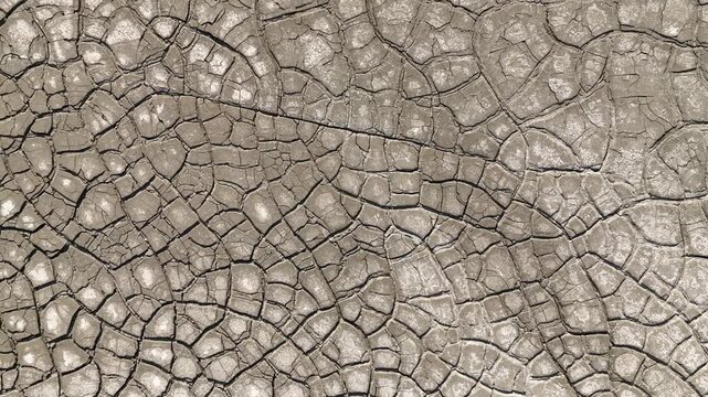 Aerial view of intricate cracked earth patterns and dry mud texture in Minas de Riotinto, Andalusia, Spain.