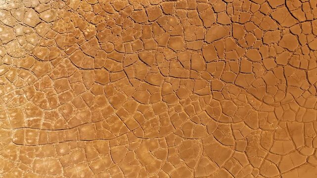 Aerial view of cracked red earth and dry mud patterns in the mining landscape of Minas de Riotinto, Andalusia, Spain.