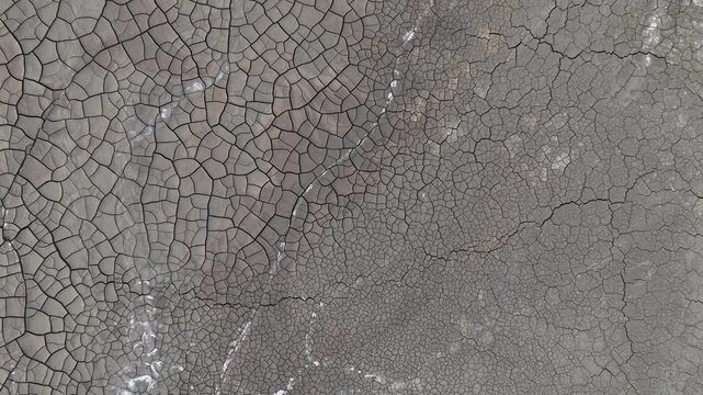 Aerial view of the intricate patterns of cracked dry earth and mineral deposits in the mining landscape of Minas de Riotinto, Andalusia, Spain.