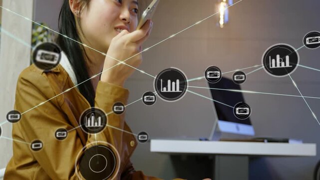 Vertical video: Woman speaking into phone and using notes, voice input growing tech network over PC