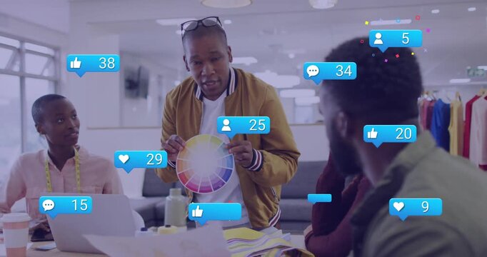 presenter rotating color wheel driving social icons rising while team viewing samples for reach