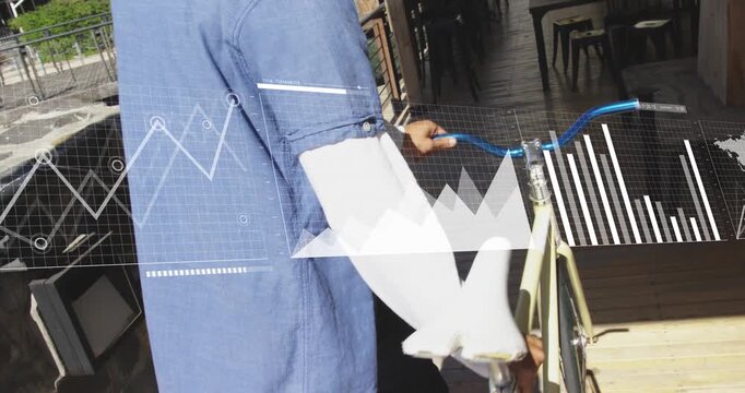Hand gripping blue handlebars activating data charts and map as rider pushing bicycle toward patio