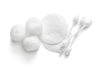 Cotton buds with balls and pads on white background