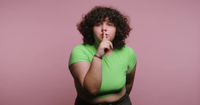 Person shows different hand signals to express ideas in front of pink background