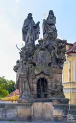 Obraz premium The large statues of Saints John of Matha, Felix of Valois, and Ivan on Charles Bridge in Prague