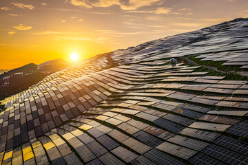 Solar power plant on mountain slopes at sunset, panoramic view. Renewable energy concept. © ABCDstock