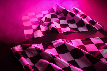 Racing flags on dark pink background, closeup © Pixel-Shot