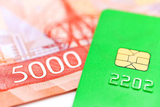 Bank card and cash in Russian banknotes showing concept of savings and honest transactions