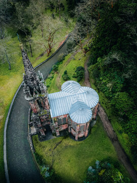 Aerial view of Ermida da Senhora da Vitoria's gothic architecture stands in stark contrast to the lush green landscape, Furnas, Portugal.