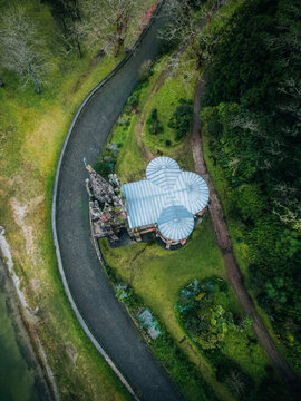 Aerial view of Ermida da Senhora da Vitoria's gothic architecture stands in stark contrast to the lush green landscape, Furnas, Portugal.