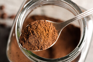 Spoon with coffee powder on grey background, closeup © Pixel-Shot