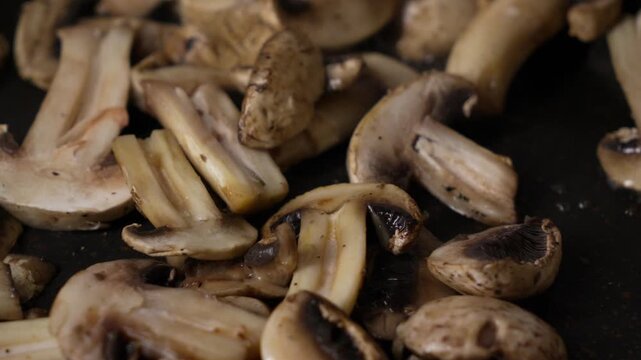 Sliced champignon mushrooms cooking in March for a warm meal
