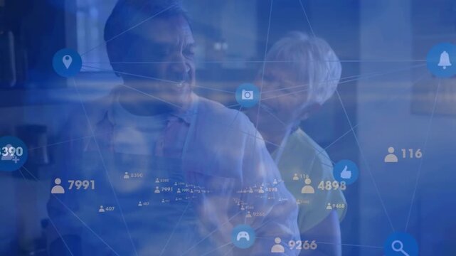 Animation of social media icons over happy senior couple at embracing