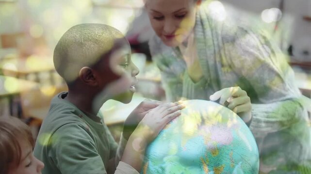 Animation of trees and leaves over diverse schoolchildren and teacher looking at globe