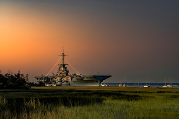 The early morning sunrise lights the U.S.S. Yorktown at Patriot's Point in Charleston South Carolina.  © jason