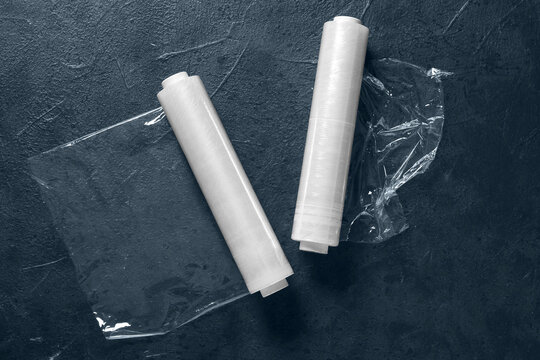 Rolls of stretch wrap on dark background, top view