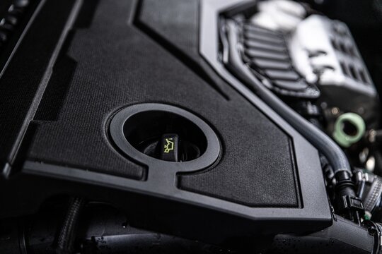 Close-up of an engine oil filler cap located in a modern car engine bay. Essential component for adding engine oil and maintaining proper lubrication and performance.