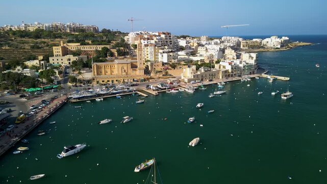 Marsaskala church and harbor, Malta, coastal architecture, fishing boats and calm sea