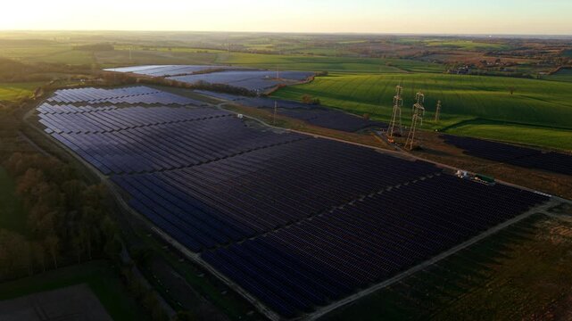 Aerial view of the expansive solar farm at Tye Lane contrasting with lush green fields, capturing the transition to sustainable energy, Ipswich, United Kingdom.