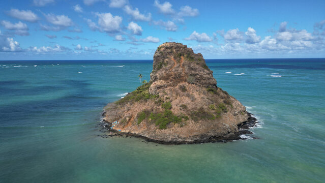 Aerial view of Chinaman's Hat Island, a basalt islet with steep cliffs, contrasts against the turquoise ocean, Kaneohe, Hawaii, United States.